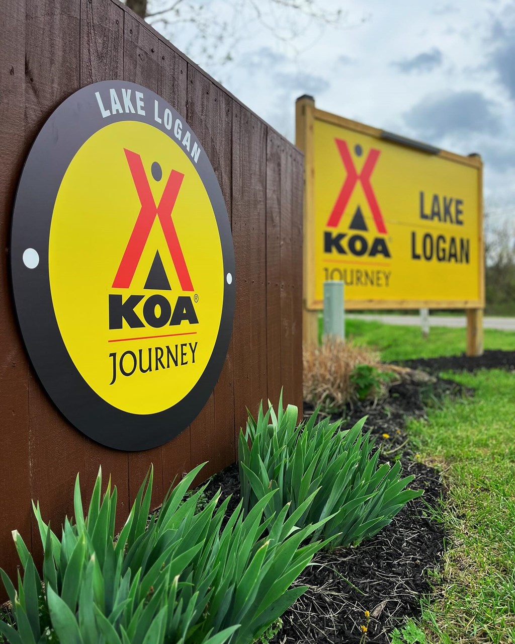 Closeup of yellow sign at Lake Logan KOA Journey