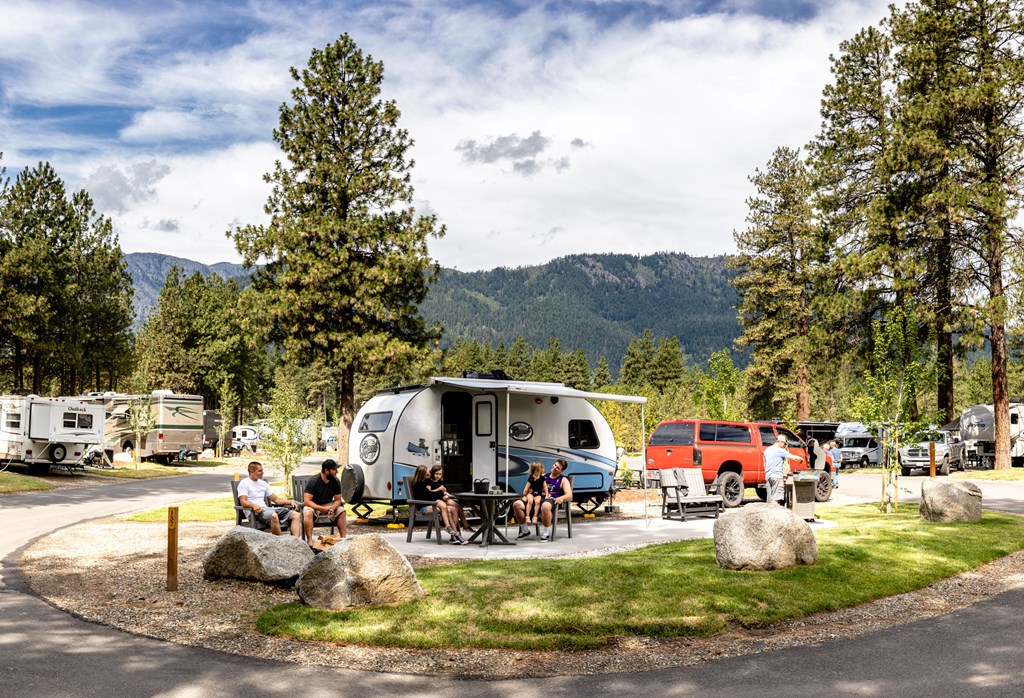 A small travel trailer on a KOA Patio RV site at a KOA campground.